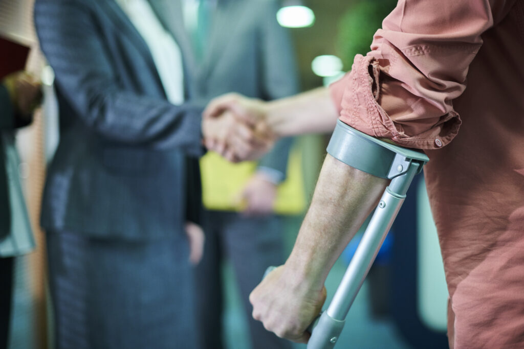 personal injury lawyer consulting with an injured client, client and lawyer shaking hands