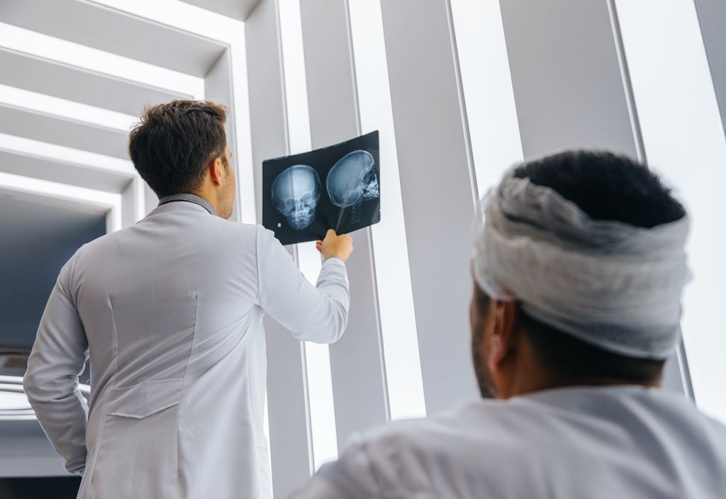 A physician reviews a test result with a car accident brain injury victim.