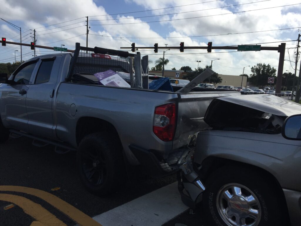 A silver truck is rear-ended at a stoplight on US-19 in Pinellas County, FL.