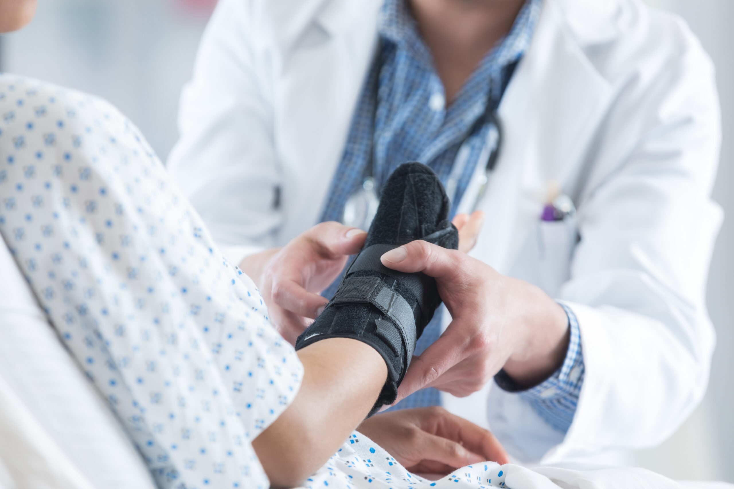 A doctor fits a car accident patient with a brace for their wrist. 